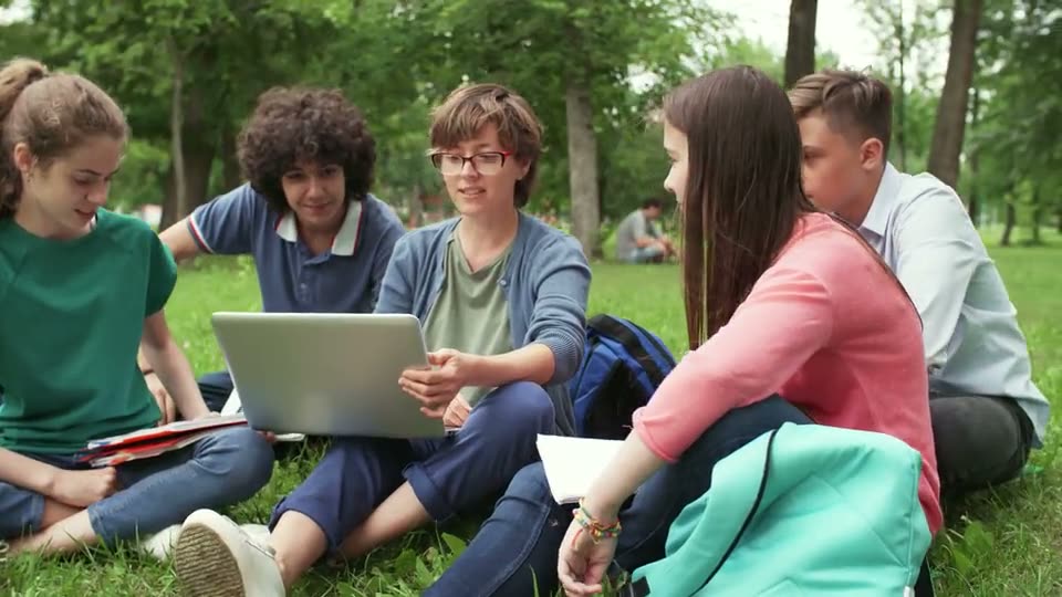 Educative project — students learning together outdoors with a laptop